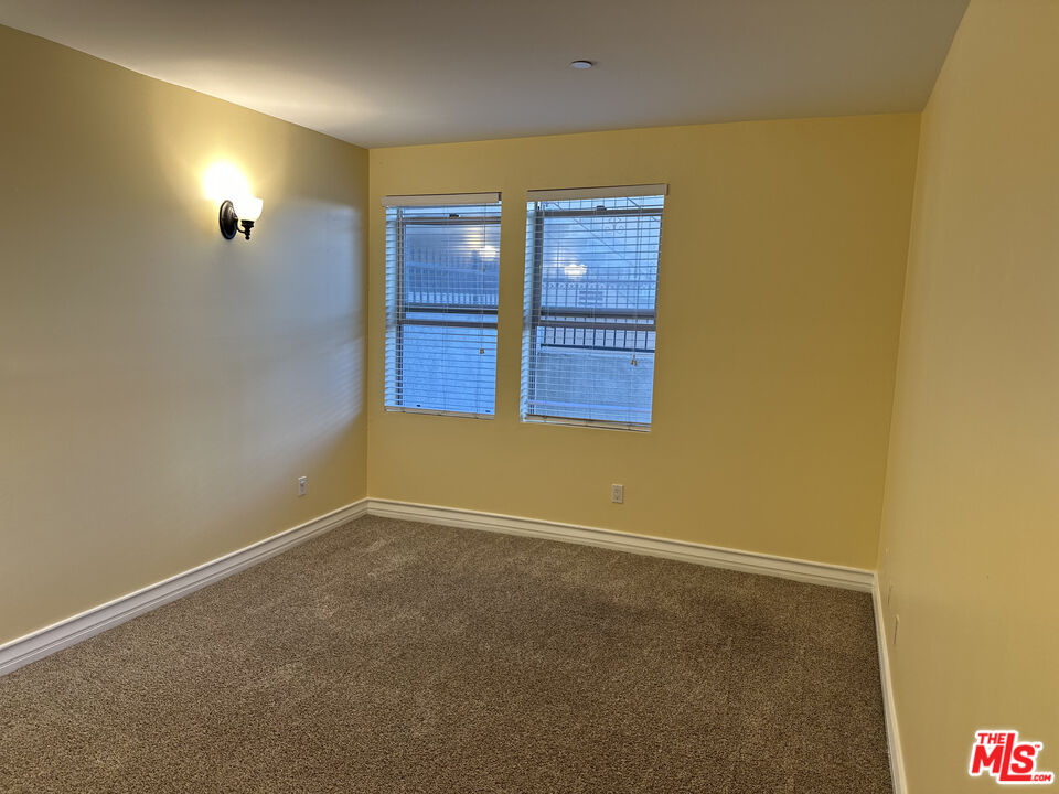 122 North Clark Drive, Unit 105 West Hollywood, CA 90048 - Photo 26 of 28 an empty room with windows