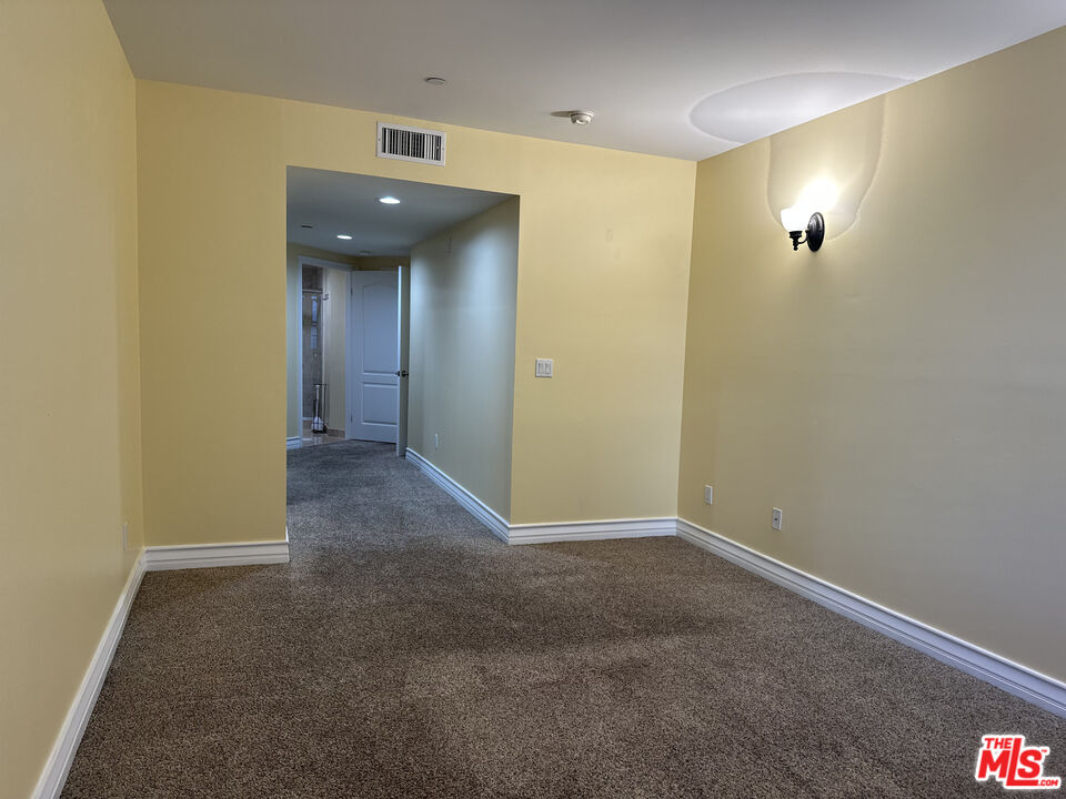 122 North Clark Drive, Unit 105 West Hollywood, CA 90048 - Photo 27 of 28 a view of a hallway with wooden floor