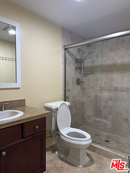 122 North Clark Drive, Unit 105 West Hollywood, CA 90048 - Photo 28 of 28 a white toilet sitting next to a bathroom sink