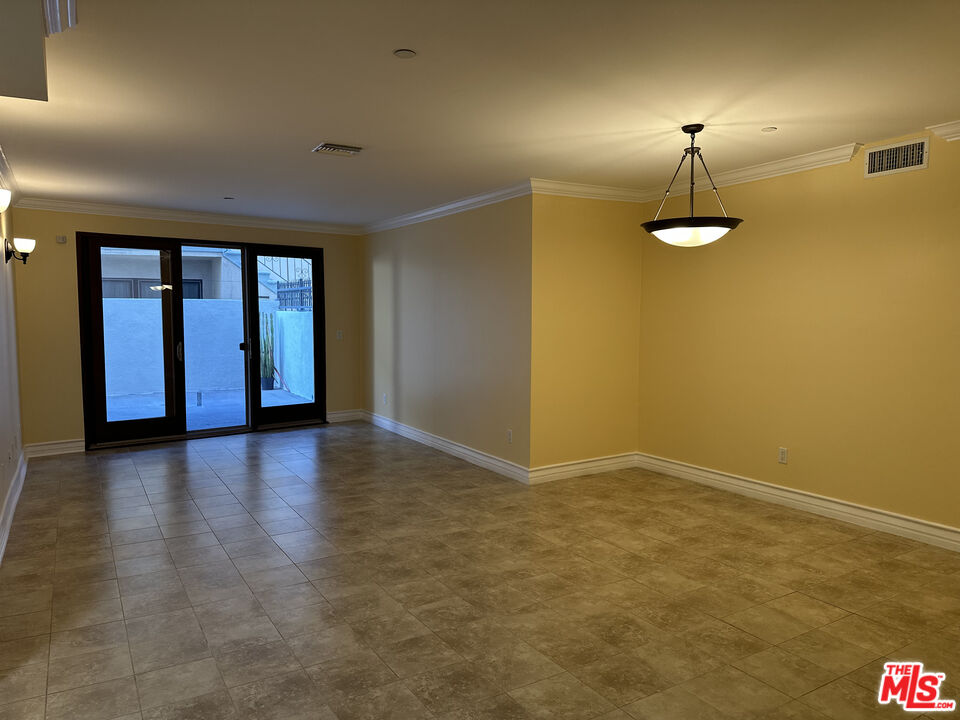 122 North Clark Drive, Unit 105 West Hollywood, CA 90048 - Photo 4 of 28 an empty room with a empty space and windows