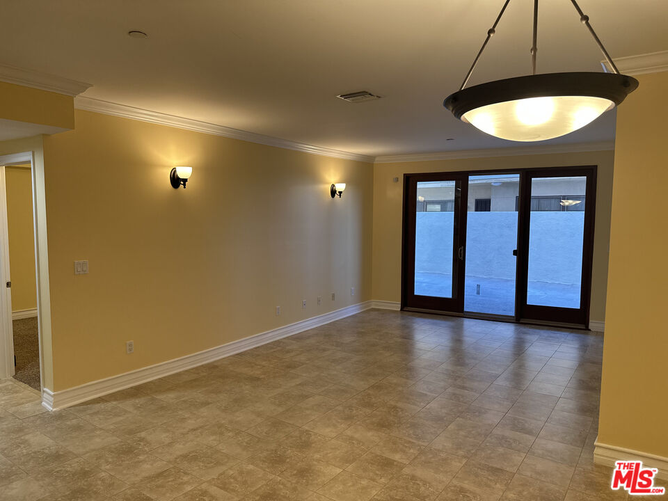 122 North Clark Drive, Unit 105 West Hollywood, CA 90048 - Photo 5 of 28 an empty room with a empty space and a ceiling fan