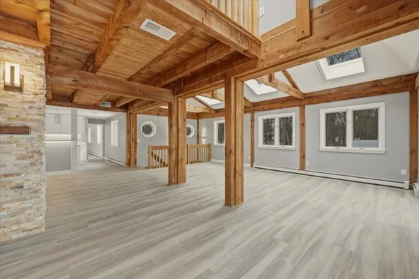 a view of an entryway with wooden floor