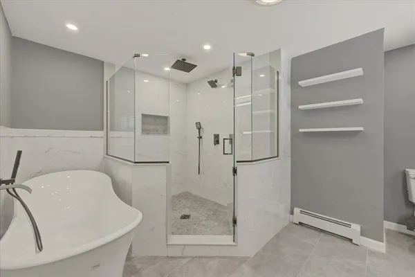 a bathroom with a shower sink and mirror