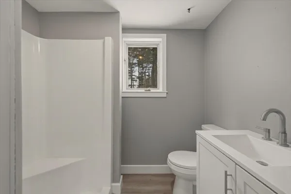 a white toilet sitting next to a bathroom sink