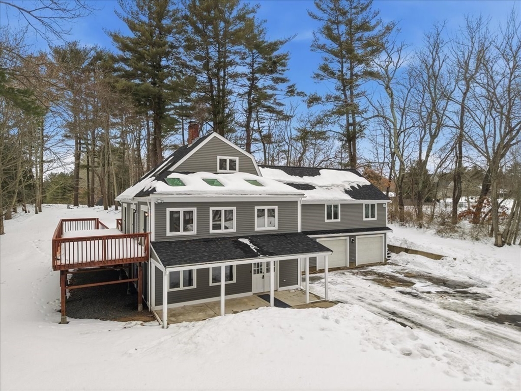 98 Walnut Street Halifax, MA 02338 - Photo 35 of 36 a front view of a house with a wooden bench next to a road