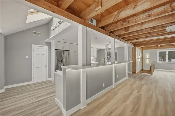 a view of a hallway with wooden floor and staircase