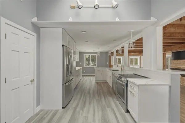 a view of a hallway with wooden floor and floors