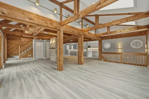 a view of a room with wooden floor