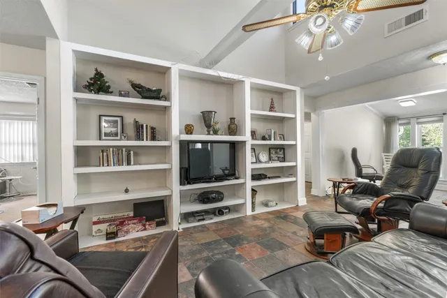 a living room with furniture cabinets and a window