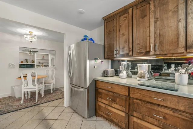 a kitchen with stainless steel appliances granite countertop a refrigerator and a stove top oven