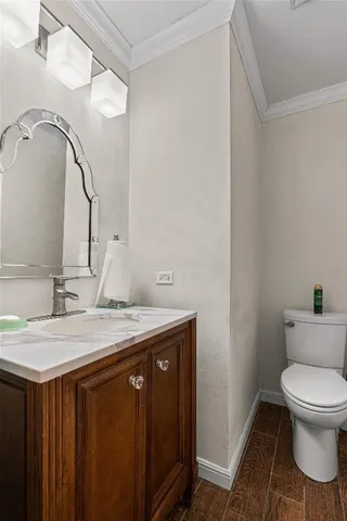 a bathroom with a granite countertop sink a toilet and a mirror