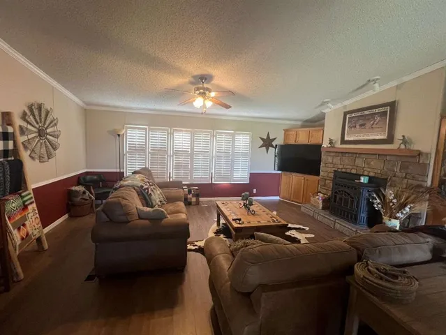a living room with furniture a large window and a flat screen tv