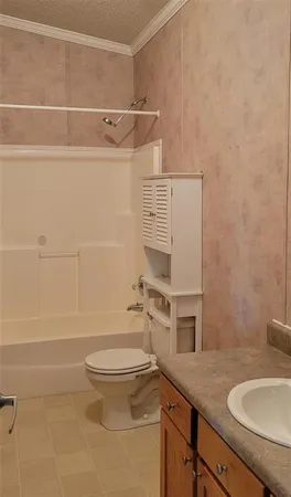 a bathroom with a granite countertop toilet sink and mirror