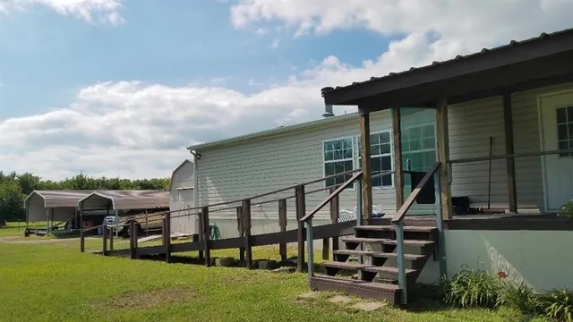 a backyard of a house with table and chairs