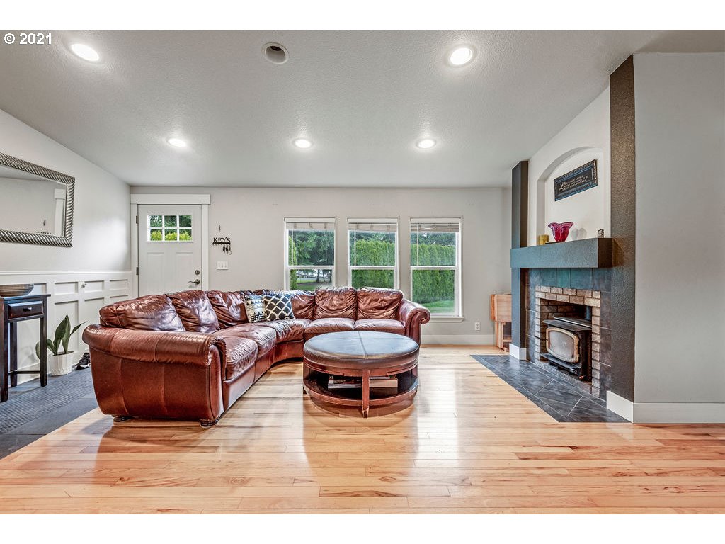 109 Highland Road Winlock, WA 98596 - Photo 14 of 28 a living room with fireplace furniture and a wooden floor