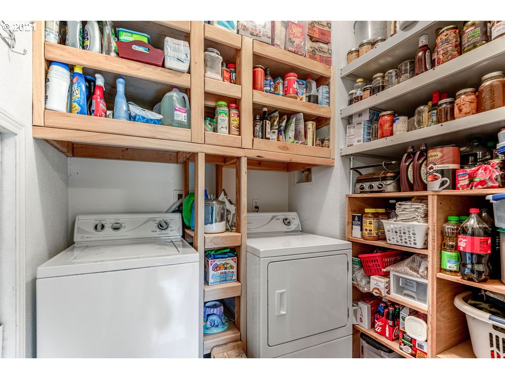 109 Highland Road Winlock, WA 98596 - Photo 21 of 28 a utility room with dryer and book shelf