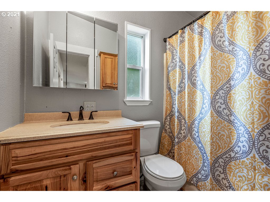 109 Highland Road Winlock, WA 98596 - Photo 28 of 28 a bathroom with a sink toilet and mirror
