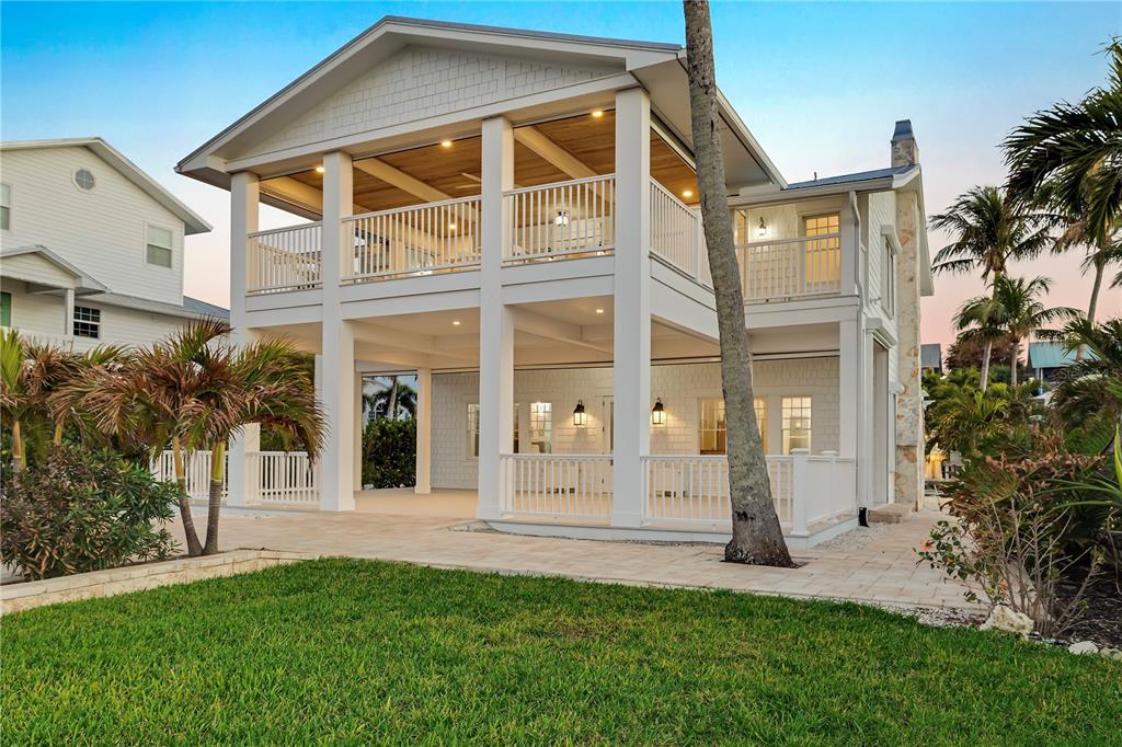 8241 Main Street Bokeelia, FL 33922 - Photo 11 of 100 a front view of a house with a yard