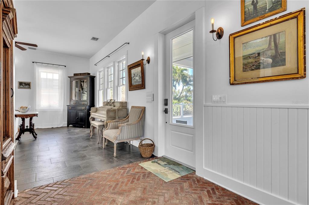 8241 Main Street Bokeelia, FL 33922 - Photo 27 of 100 a living room with furniture and a painting on the wall