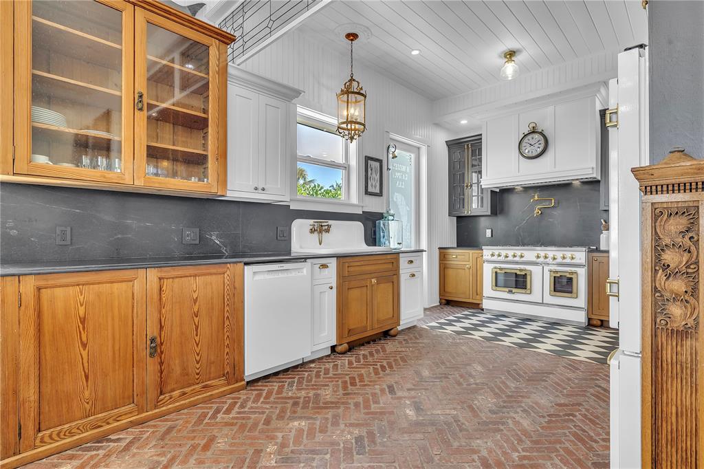 8241 Main Street Bokeelia, FL 33922 - Photo 32 of 100 a kitchen with stainless steel appliances granite countertop a stove a sink and a granite counter tops with white cabinets