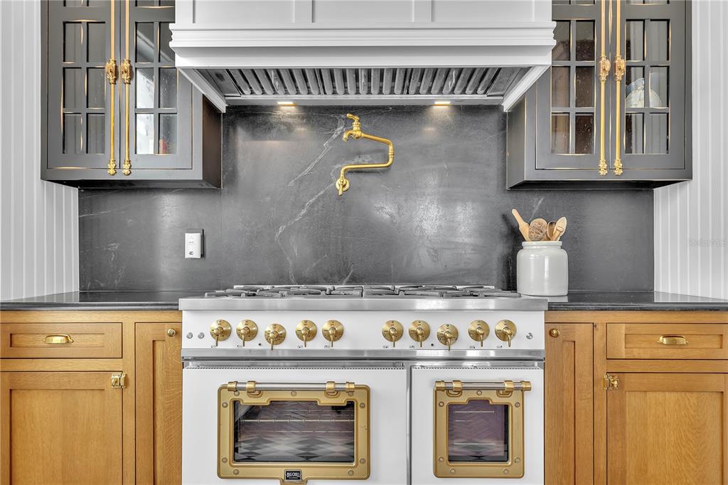 8241 Main Street Bokeelia, FL 33922 - Photo 39 of 100 a stove top oven sitting inside of a kitchen