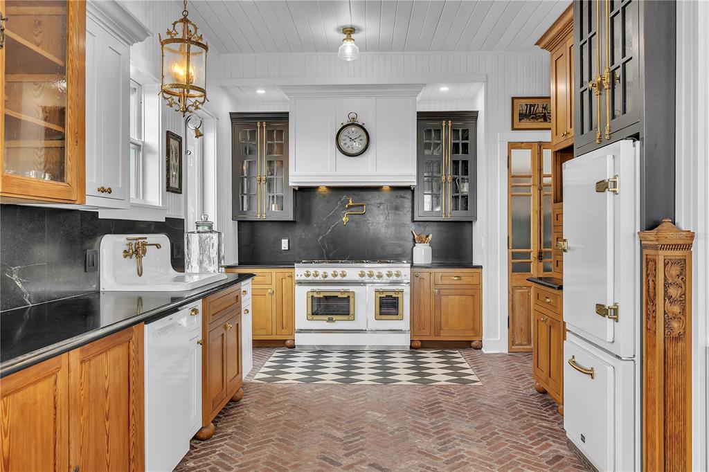 8241 Main Street Bokeelia, FL 33922 - Photo 4 of 100 a kitchen with stainless steel appliances granite countertop a stove a sink and a refrigerator