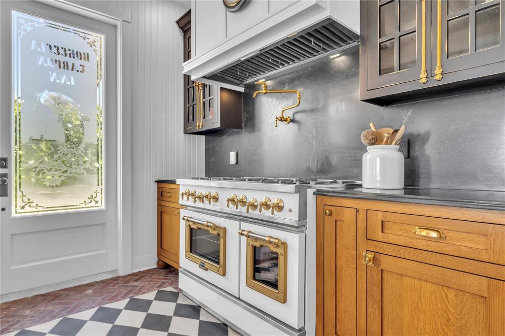 8241 Main Street Bokeelia, FL 33922 - Photo 41 of 100 a kitchen with stainless steel appliances granite countertop a stove and a microwave