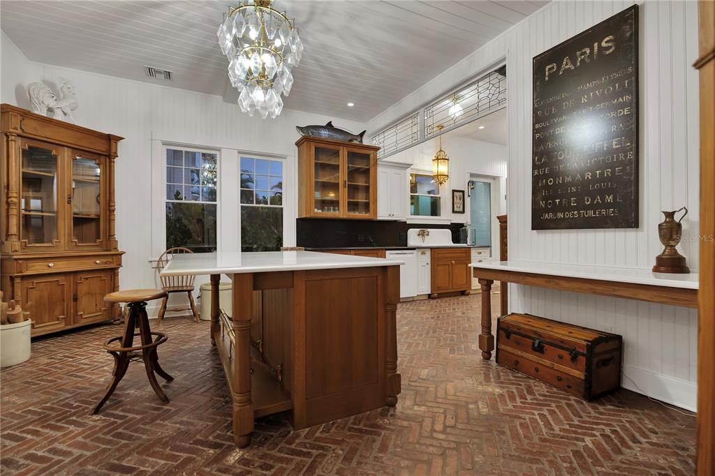 8241 Main Street Bokeelia, FL 33922 - Photo 45 of 100 a living room with furniture a dining table and paintings on the wall