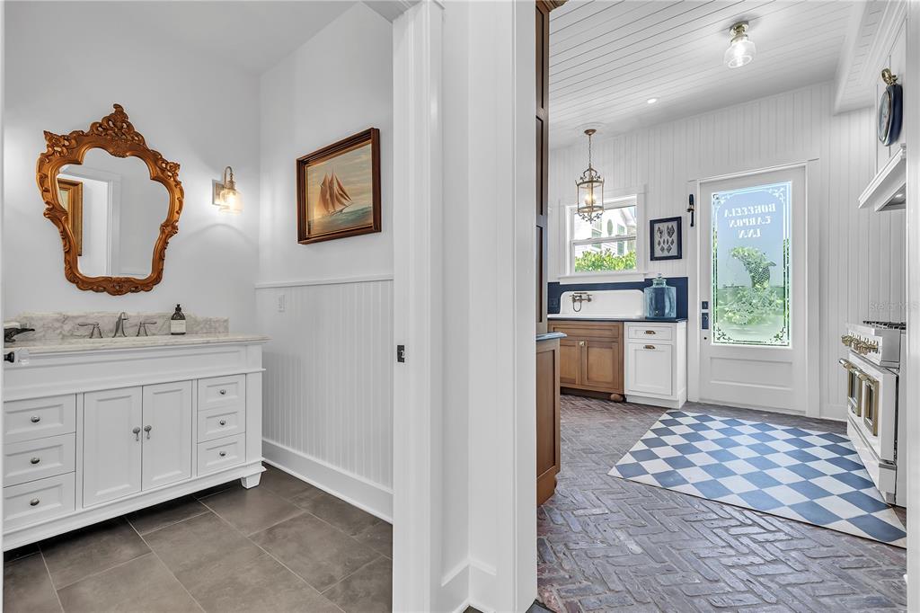 8241 Main Street Bokeelia, FL 33922 - Photo 48 of 100 a bathroom with a sink a mirror and a toilet