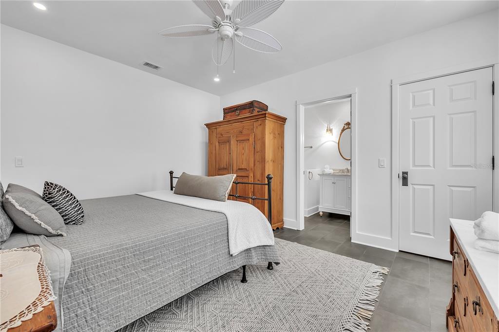 8241 Main Street Bokeelia, FL 33922 - Photo 49 of 100 a bedroom with a bed and a mirror