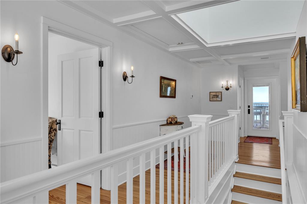 8241 Main Street Bokeelia, FL 33922 - Photo 59 of 100 a view of a hallway with a large mirror and a projector