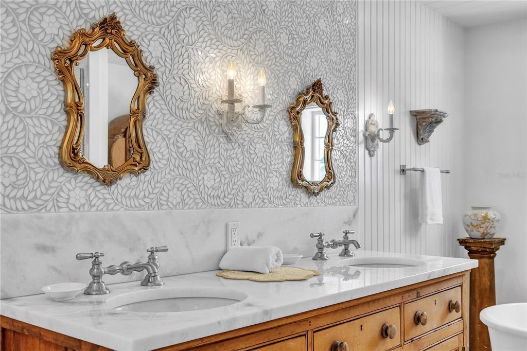 8241 Main Street Bokeelia, FL 33922 - Photo 66 of 100 a bathroom with a sink and a mirror