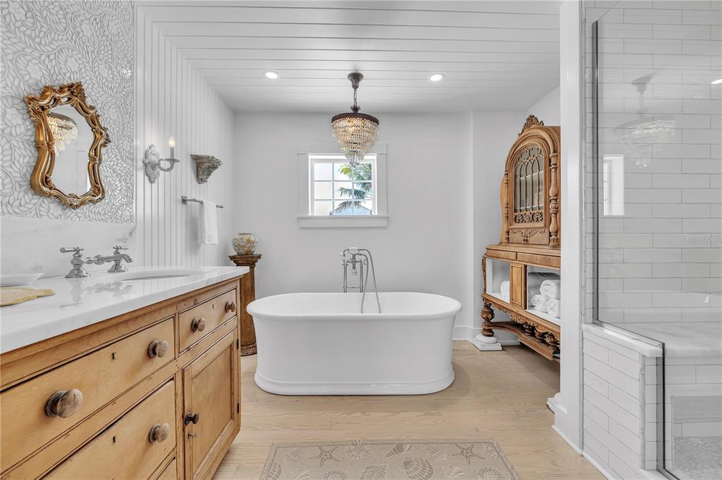 8241 Main Street Bokeelia, FL 33922 - Photo 7 of 100 a spacious bathroom with a double vanity sink mirror and bathtub