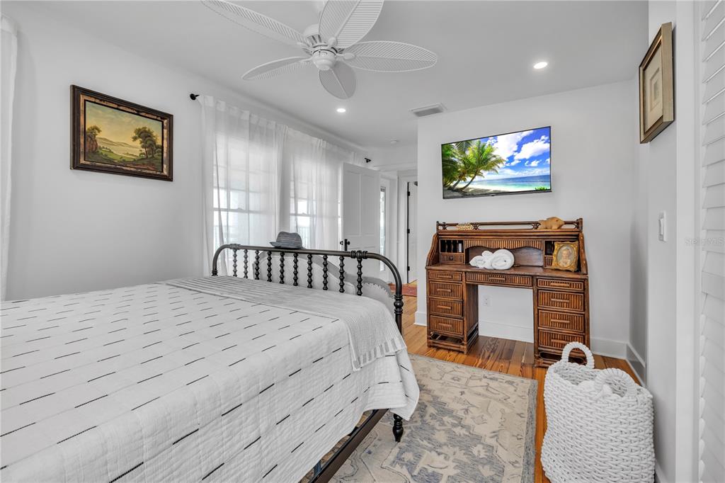 8241 Main Street Bokeelia, FL 33922 - Photo 73 of 100 a bedroom with a bed and a flat screen tv