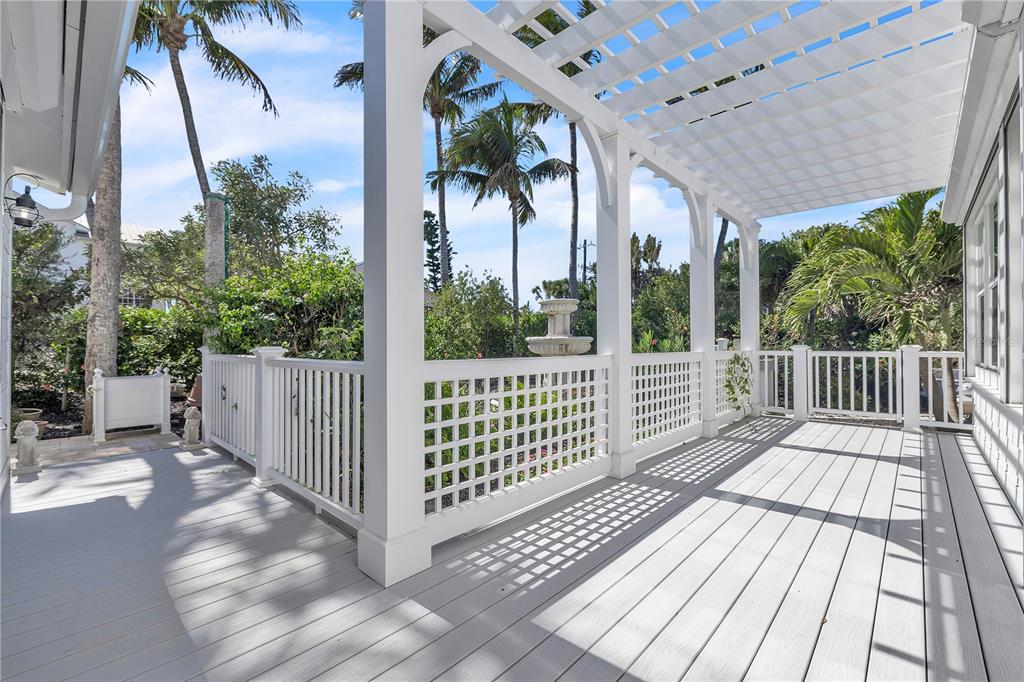 8241 Main Street Bokeelia, FL 33922 - Photo 84 of 100 a view of a wooden deck with a yard
