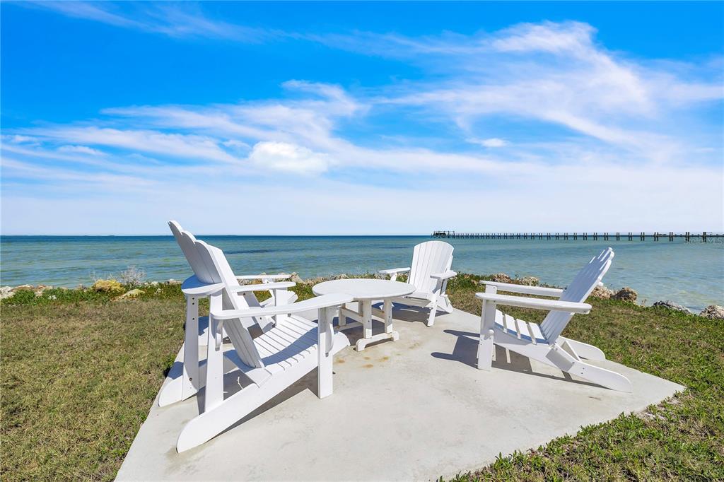 8241 Main Street Bokeelia, FL 33922 - Photo 97 of 100 a view of a terrace with chairs