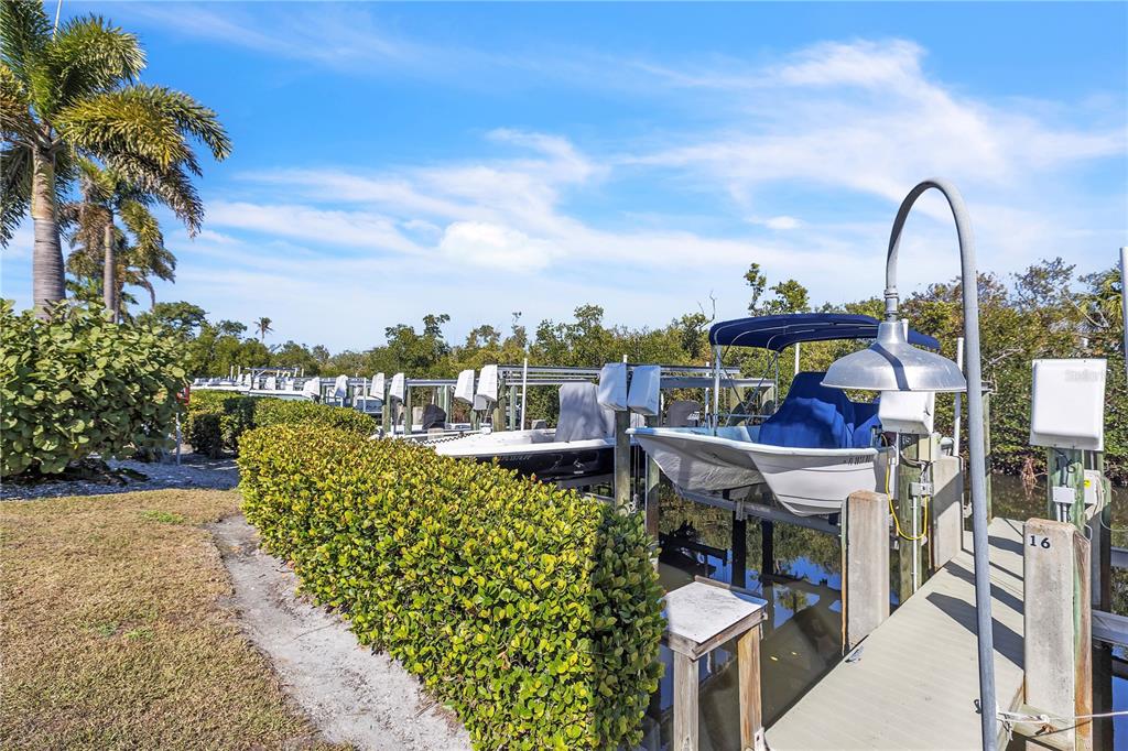 8241 Main Street Bokeelia, FL 33922 - Photo 99 of 100 a view of a swimming pool with outdoor seating and plants