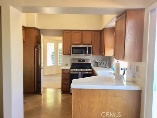 a kitchen with a stove a sink and a microwave