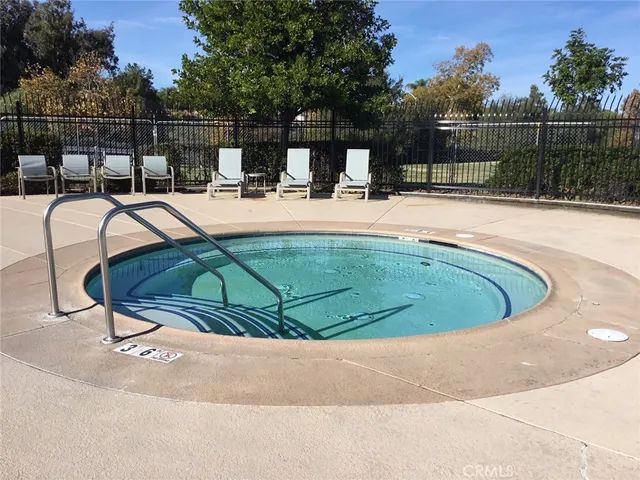 a swimming pool with outdoor seating and yard