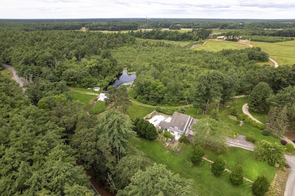 107 Wareham Street Carver, MA 02330 - Photo 1 of 25 a view of a lake with a yard