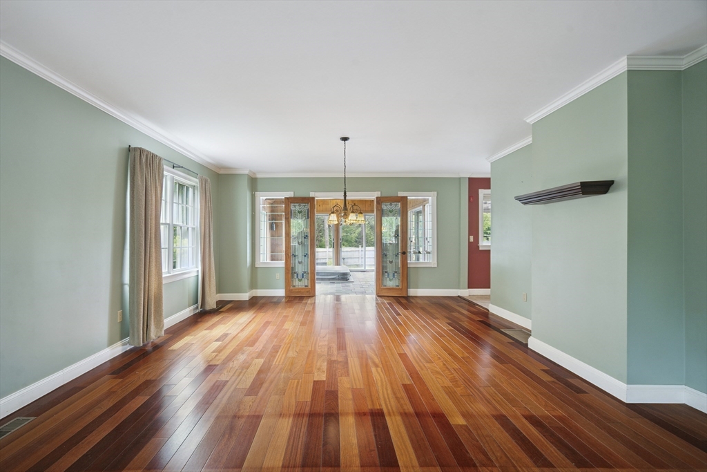 107 Wareham Street Carver, MA 02330 - Photo 11 of 25 a view of an empty room with wooden floor and a window