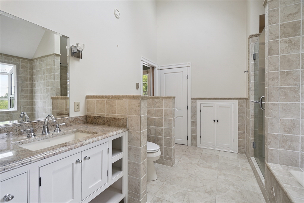 107 Wareham Street Carver, MA 02330 - Photo 17 of 25 a bathroom with a granite countertop sink a toilet a mirror and shower