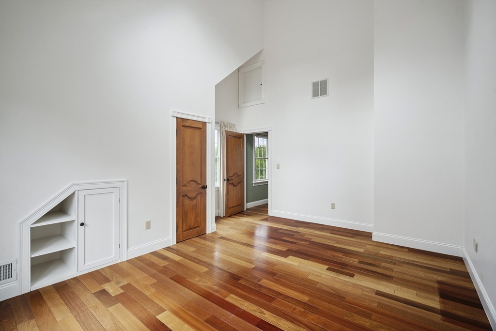 107 Wareham Street Carver, MA 02330 - Photo 20 of 25 a view of an empty room with a fireplace and a window