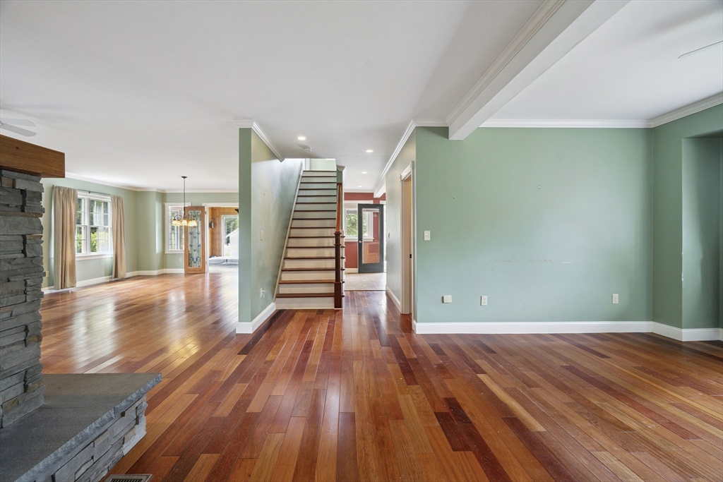 107 Wareham Street Carver, MA 02330 - Photo 6 of 25 a view of a room with wooden floors and stairs
