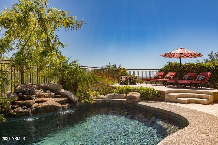 16715 North 108th Way Scottsdale, AZ 85255 - Photo 21 of 104 a view of a swimming pool and lounge chairs