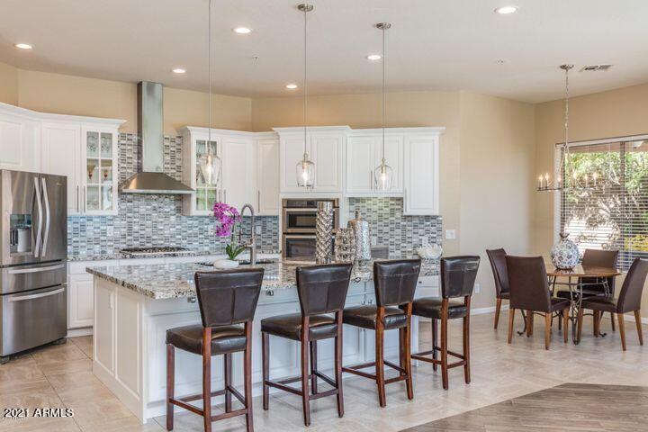 16715 North 108th Way Scottsdale, AZ 85255 - Photo 28 of 104 a kitchen with kitchen island granite countertop a table and chairs in it