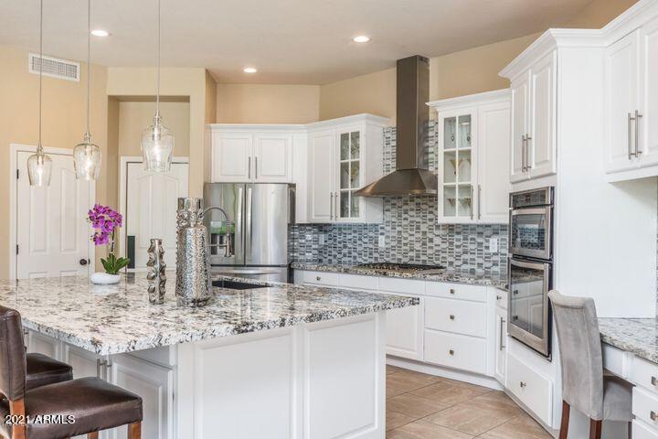 16715 North 108th Way Scottsdale, AZ 85255 - Photo 30 of 104 a kitchen with stainless steel appliances kitchen island granite countertop a sink and cabinets