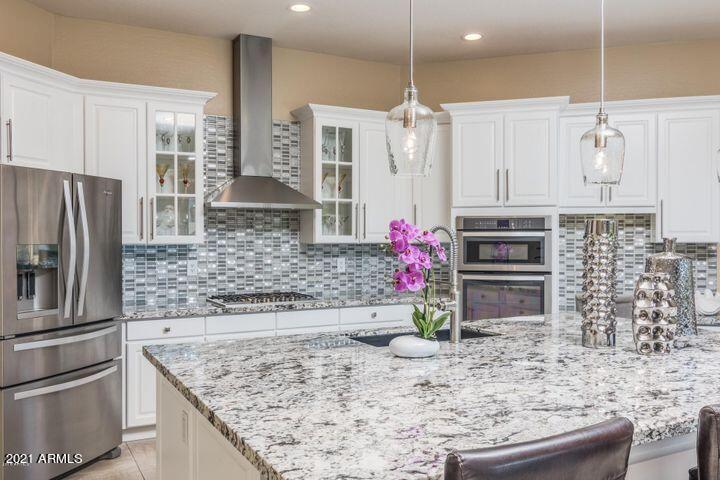 16715 North 108th Way Scottsdale, AZ 85255 - Photo 32 of 104 a kitchen with stainless steel appliances granite countertop a sink refrigerator and cabinets
