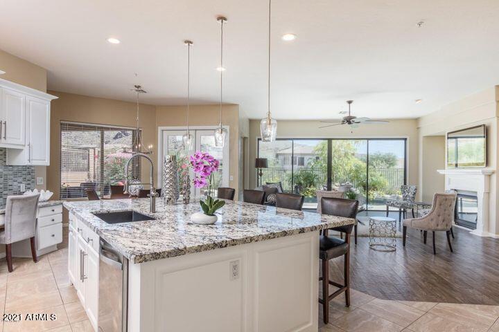 16715 North 108th Way Scottsdale, AZ 85255 - Photo 40 of 104 a kitchen with granite countertop kitchen island wooden floor dining table and a large window