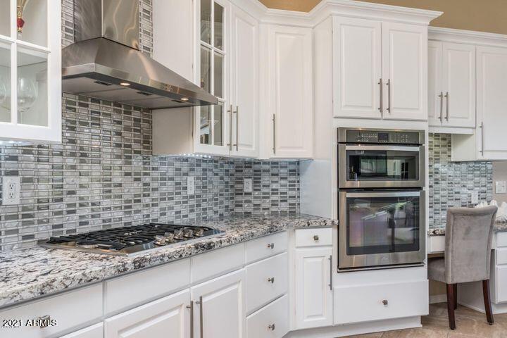 16715 North 108th Way Scottsdale, AZ 85255 - Photo 41 of 104 a kitchen with granite countertop white cabinets and stainless steel appliances